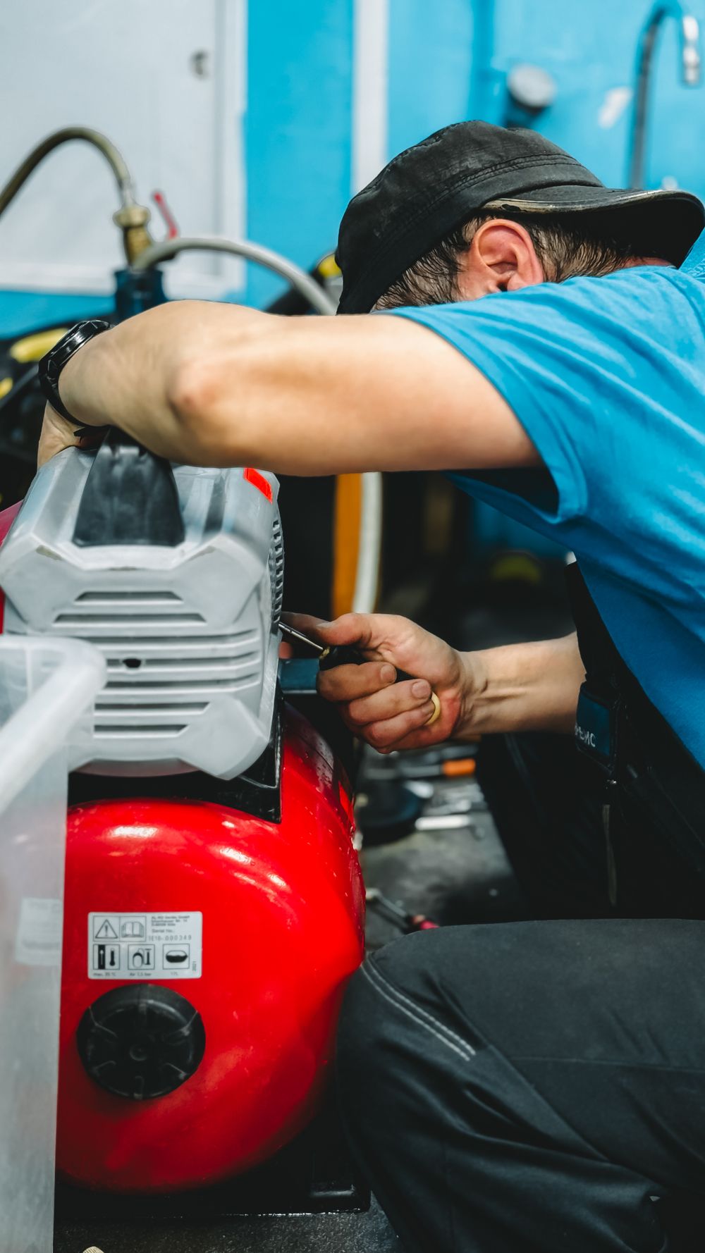 Plumber's hands tightening a fitting with a wrench